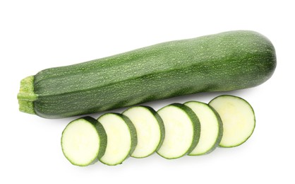 Photo of Whole and cut fresh zucchinis isolated on white, top view