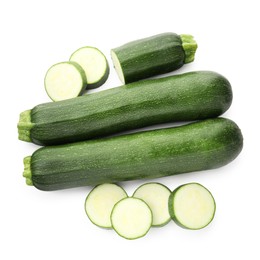 Photo of Whole and cut fresh zucchinis isolated on white, top view