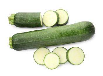 Photo of Whole and cut fresh zucchinis isolated on white, top view