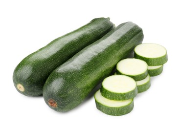 Photo of Whole and cut fresh zucchinis isolated on white