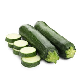 Photo of Whole and cut fresh zucchinis isolated on white