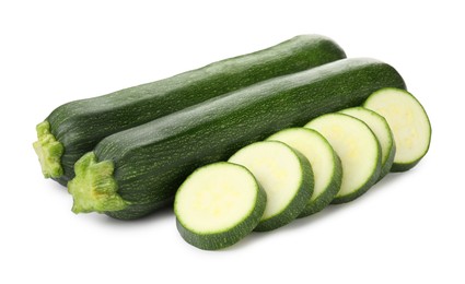 Photo of Whole and cut fresh zucchinis isolated on white