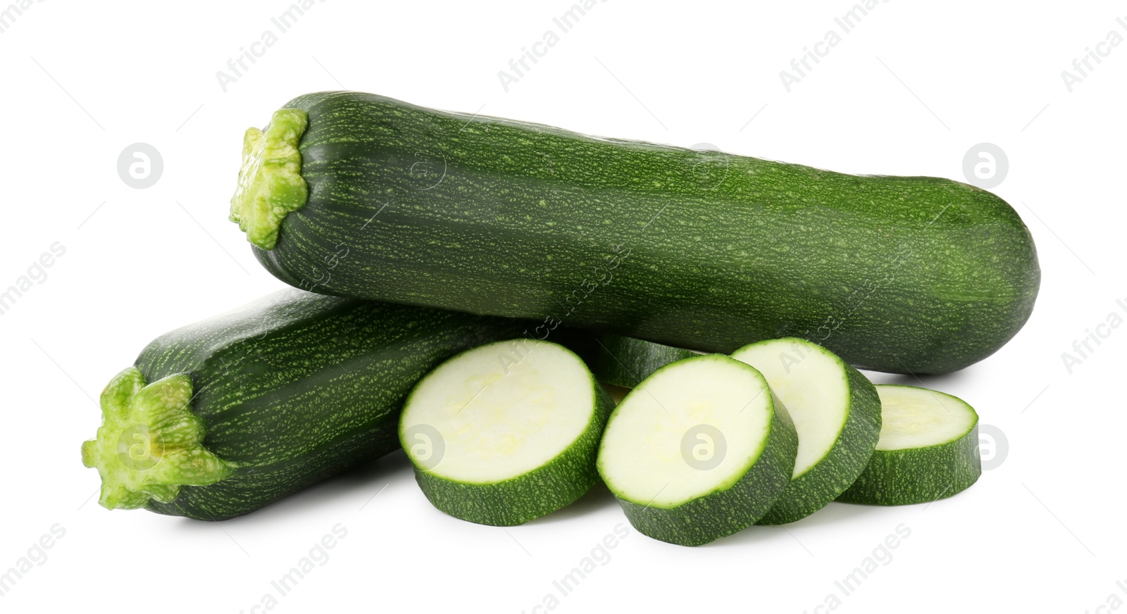 Whole and cut fresh zucchinis isolated on white Photo of Whole and cut fresh zucchinis isolated on white