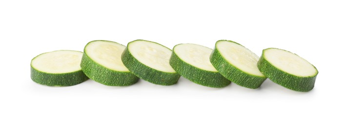 Photo of Pieces of fresh zucchini isolated on white