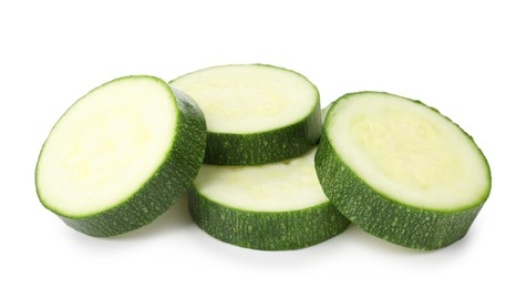 Photo of Pieces of fresh zucchini isolated on white