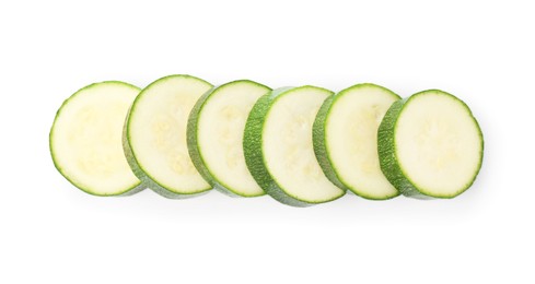 Photo of Pieces of fresh zucchini isolated on white, top view