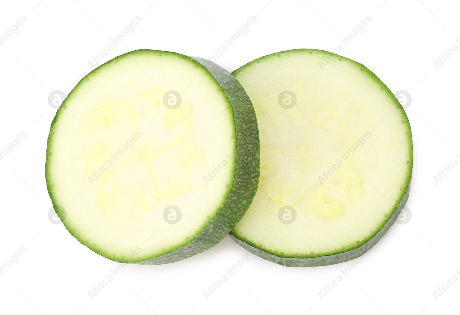 Pieces of fresh zucchini isolated on white, top view Photo of Pieces of fresh zucchini isolated on white, top view