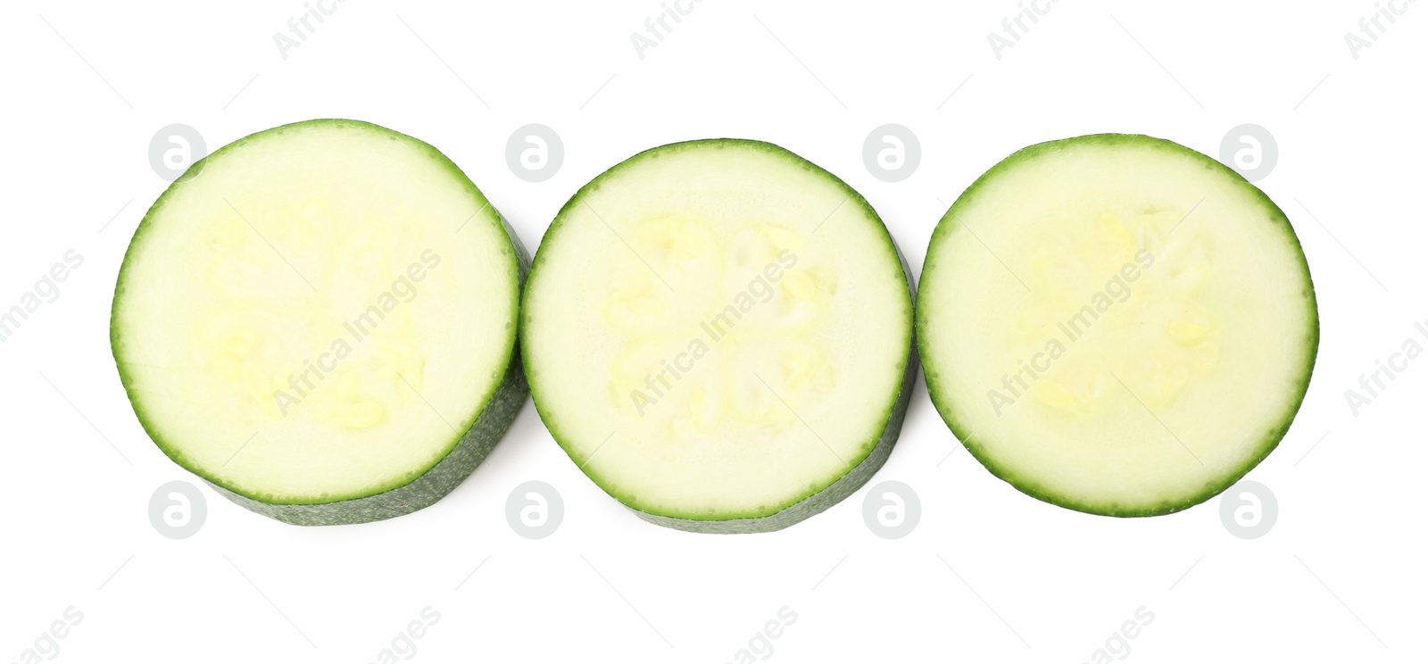 Pieces of fresh zucchini isolated on white, top view Photo of Pieces of fresh zucchini isolated on white, top view