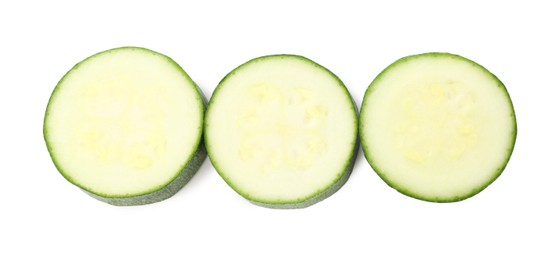 Photo of Pieces of fresh zucchini isolated on white, top view