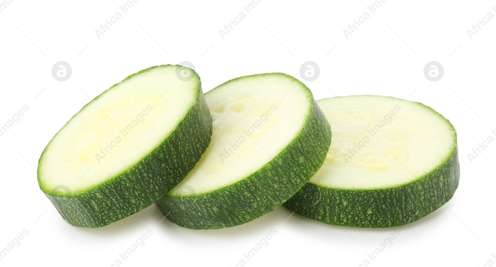 Pieces of fresh zucchini isolated on white Photo of Pieces of fresh zucchini isolated on white