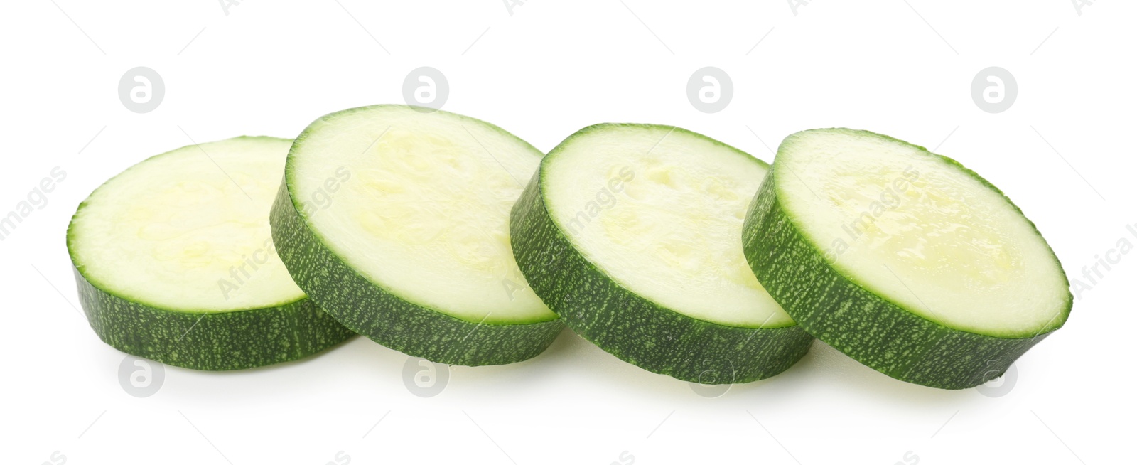 Pieces of fresh zucchini isolated on white Photo of Pieces of fresh zucchini isolated on white