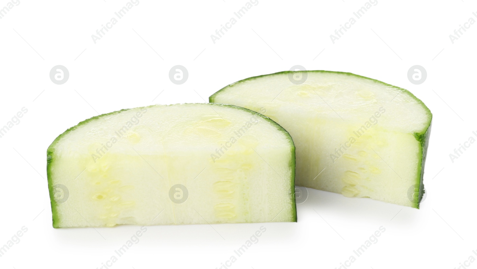 Pieces of fresh zucchini isolated on white Photo of Pieces of fresh zucchini isolated on white