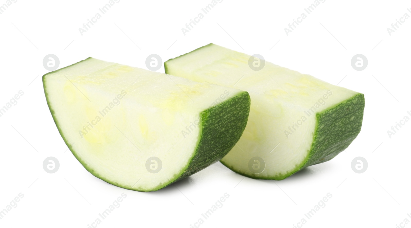 Pieces of fresh zucchini isolated on white Photo of Pieces of fresh zucchini isolated on white