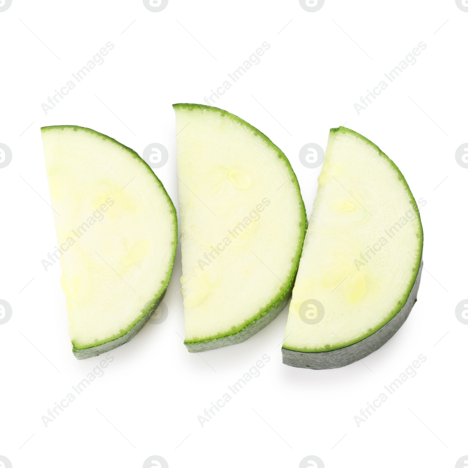Pieces of fresh zucchini isolated on white, top view Photo of Pieces of fresh zucchini isolated on white, top view