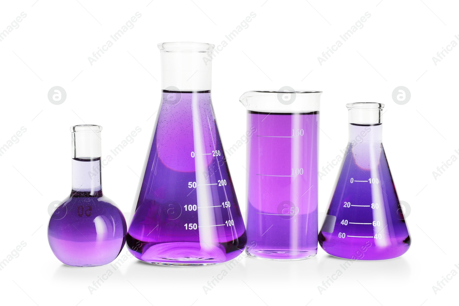 Photo of Laboratory glassware with violet liquid isolated on white