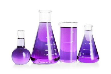 Photo of Laboratory glassware with violet liquid isolated on white
