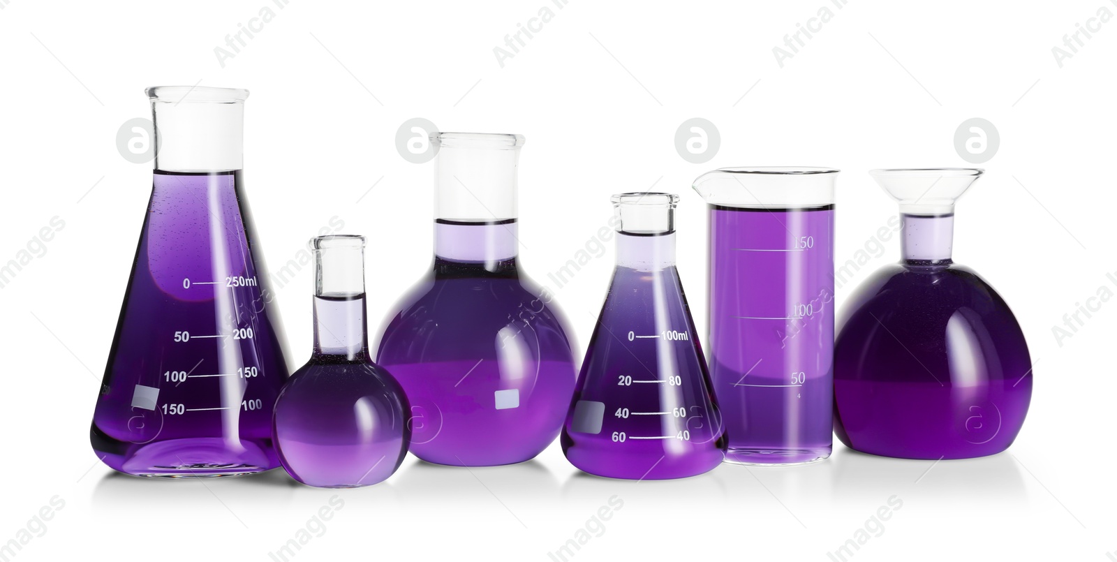 Photo of Laboratory glassware with violet liquid isolated on white