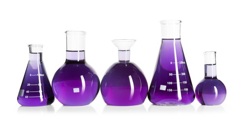 Photo of Laboratory glassware with violet liquid isolated on white