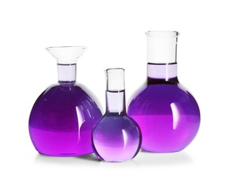 Photo of Laboratory glassware with violet liquid isolated on white