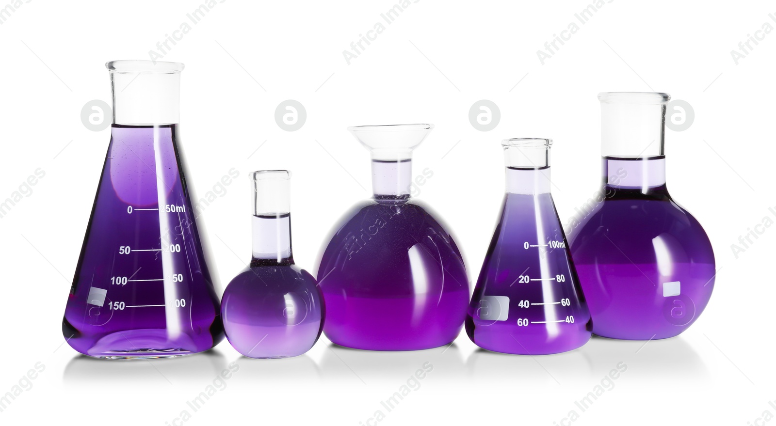 Photo of Laboratory glassware with violet liquid isolated on white