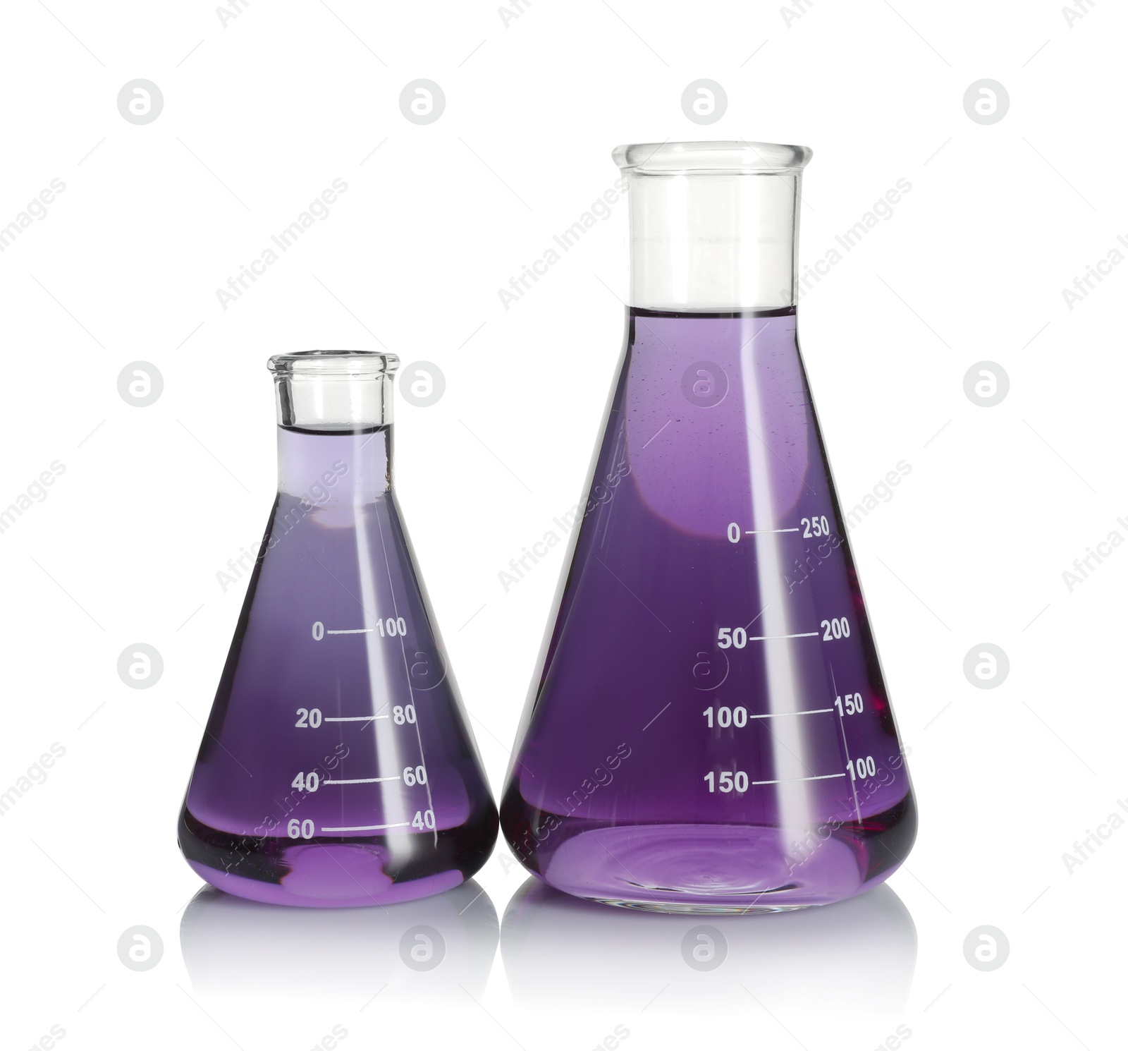 Photo of Laboratory glassware with violet liquid isolated on white