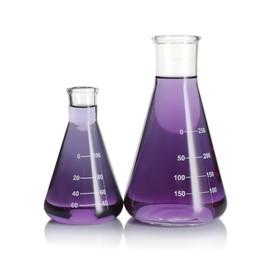 Photo of Laboratory glassware with violet liquid isolated on white