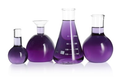 Photo of Laboratory glassware with violet liquid isolated on white