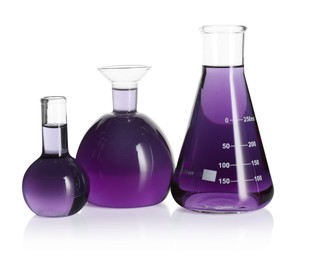 Photo of Laboratory glassware with violet liquid isolated on white