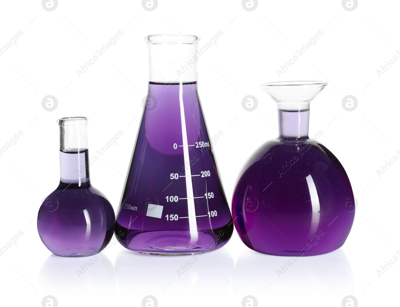 Photo of Laboratory glassware with violet liquid isolated on white