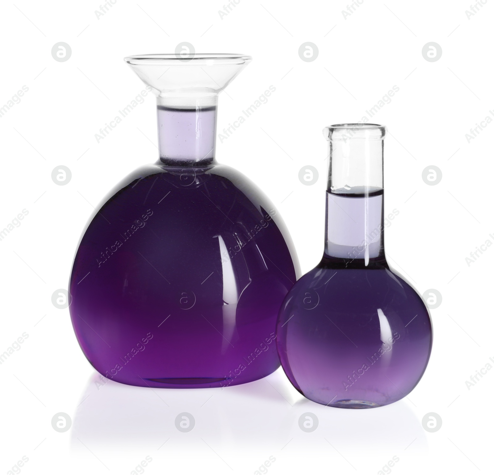 Photo of Laboratory glassware with violet liquid isolated on white