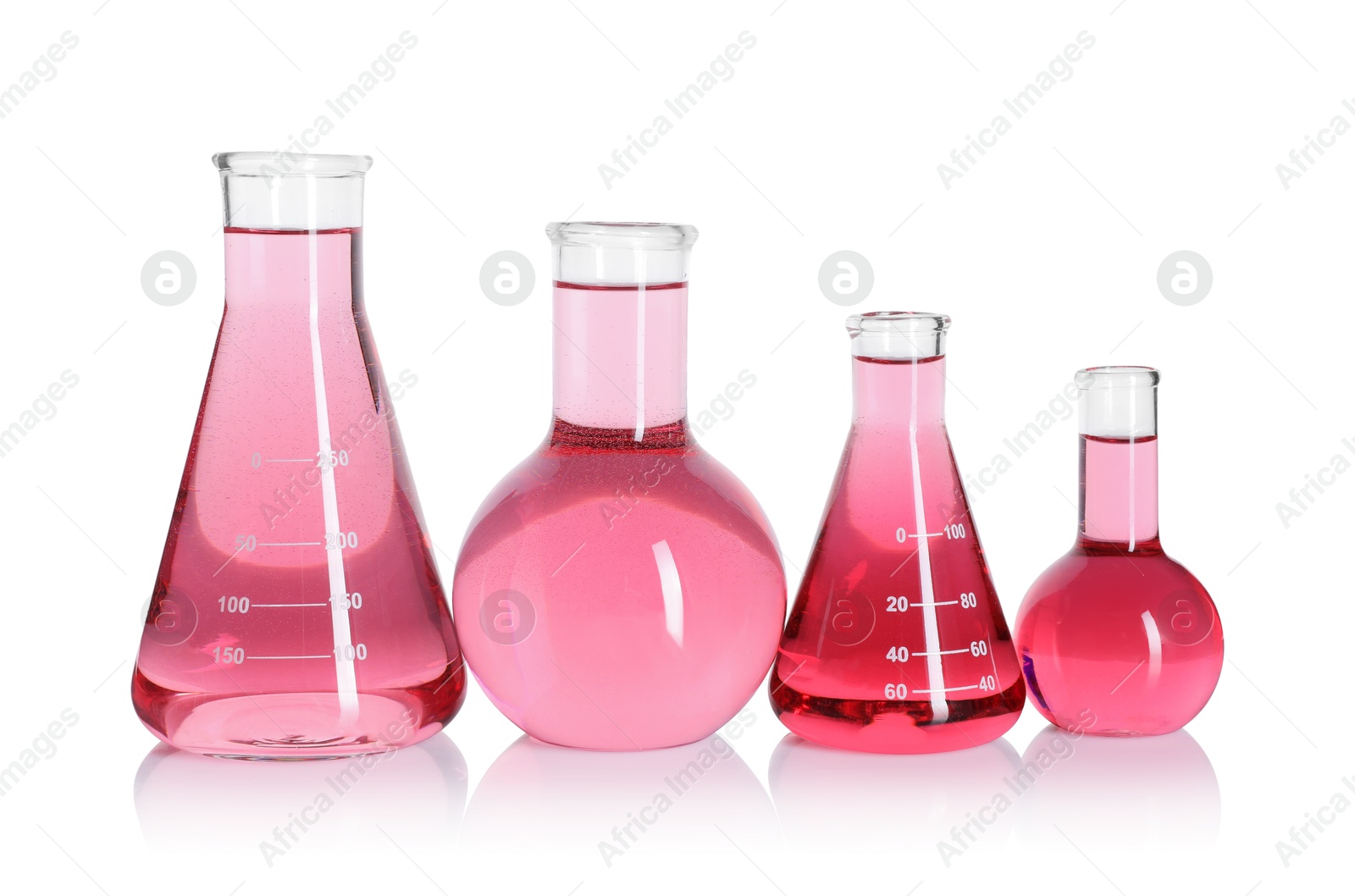 Laboratory glassware with pink liquid isolated on white Photo of Laboratory glassware with pink liquid isolated on white