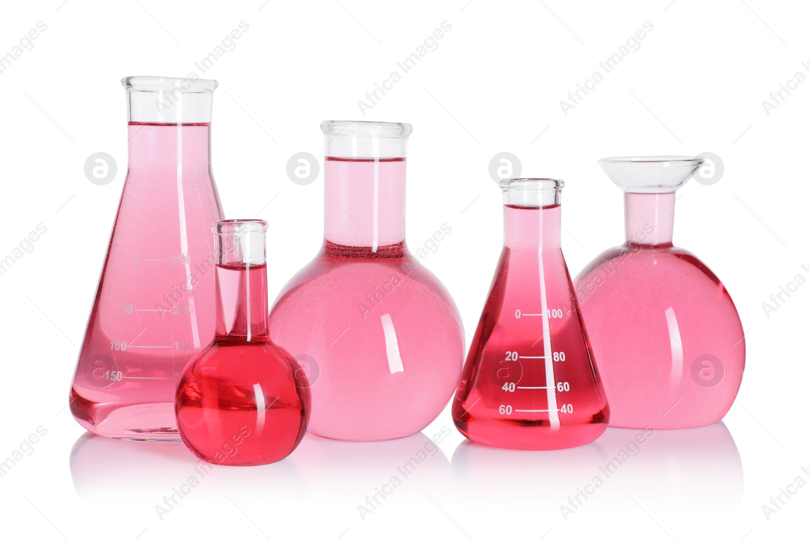 Photo of Laboratory glassware with pink liquid isolated on white