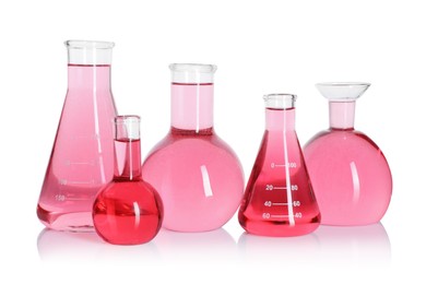 Photo of Laboratory glassware with pink liquid isolated on white