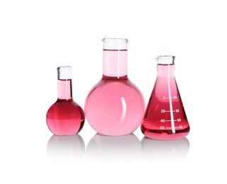 Photo of Laboratory glassware with pink liquid isolated on white