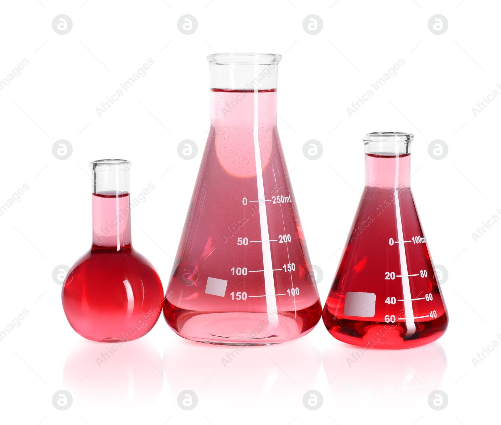Laboratory glassware with pink liquid isolated on white Photo of Laboratory glassware with pink liquid isolated on white