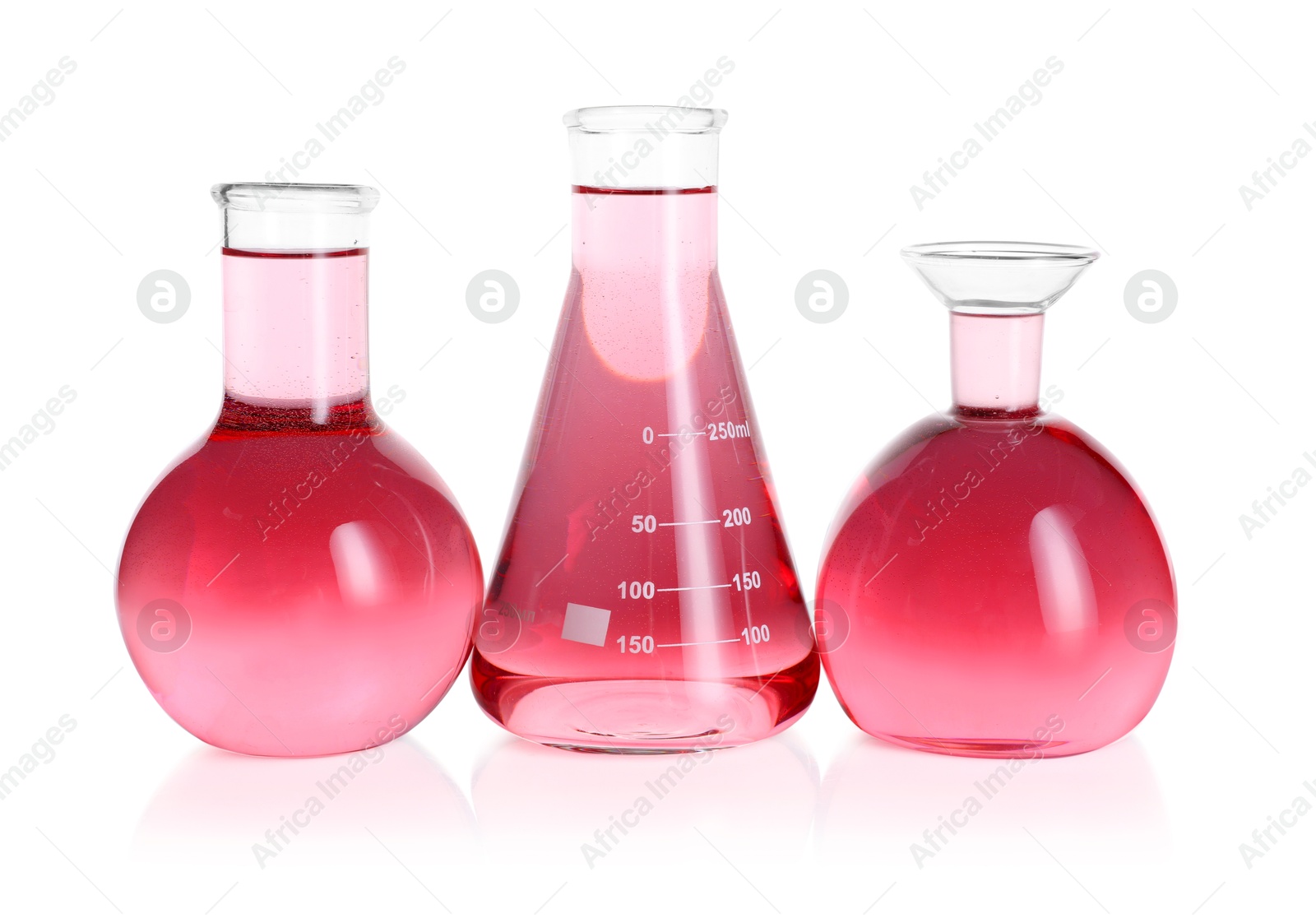 Photo of Laboratory glassware with pink liquid isolated on white