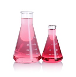 Photo of Laboratory glassware with pink liquid isolated on white