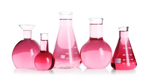 Photo of Laboratory glassware with pink liquid isolated on white
