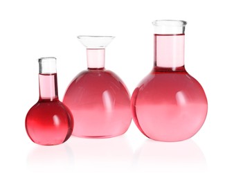 Photo of Laboratory glassware with pink liquid isolated on white
