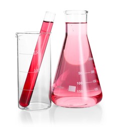 Photo of Laboratory glassware with pink liquid isolated on white