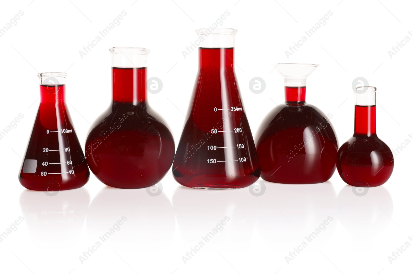 Photo of Laboratory glassware with red liquid isolated on white