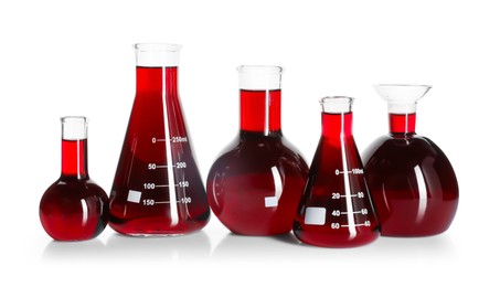 Photo of Laboratory glassware with red liquid isolated on white