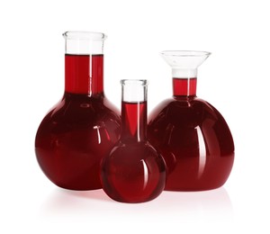 Photo of Laboratory glassware with red liquid isolated on white