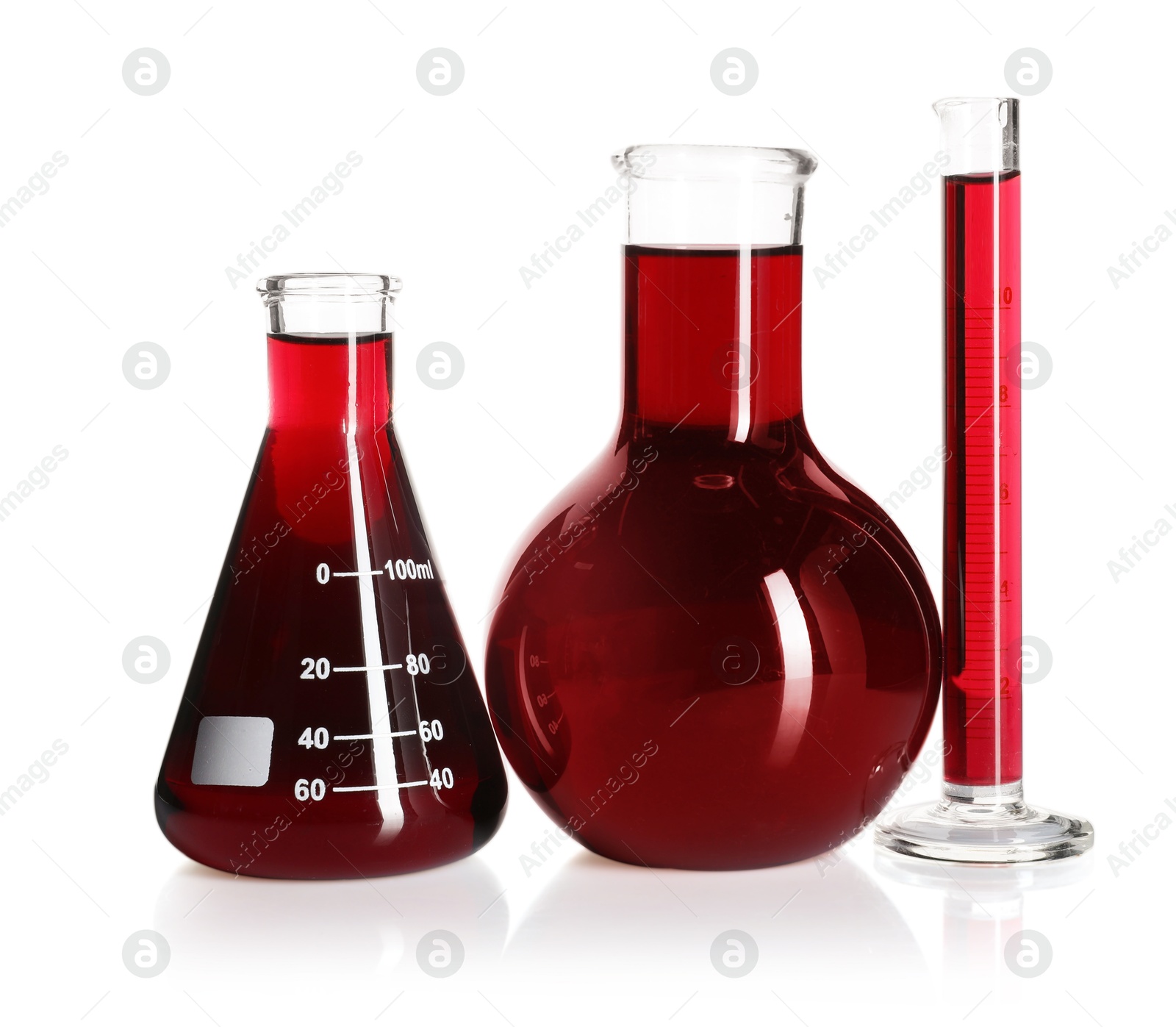 Photo of Laboratory glassware with red liquid isolated on white