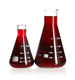 Photo of Laboratory glassware with red liquid isolated on white