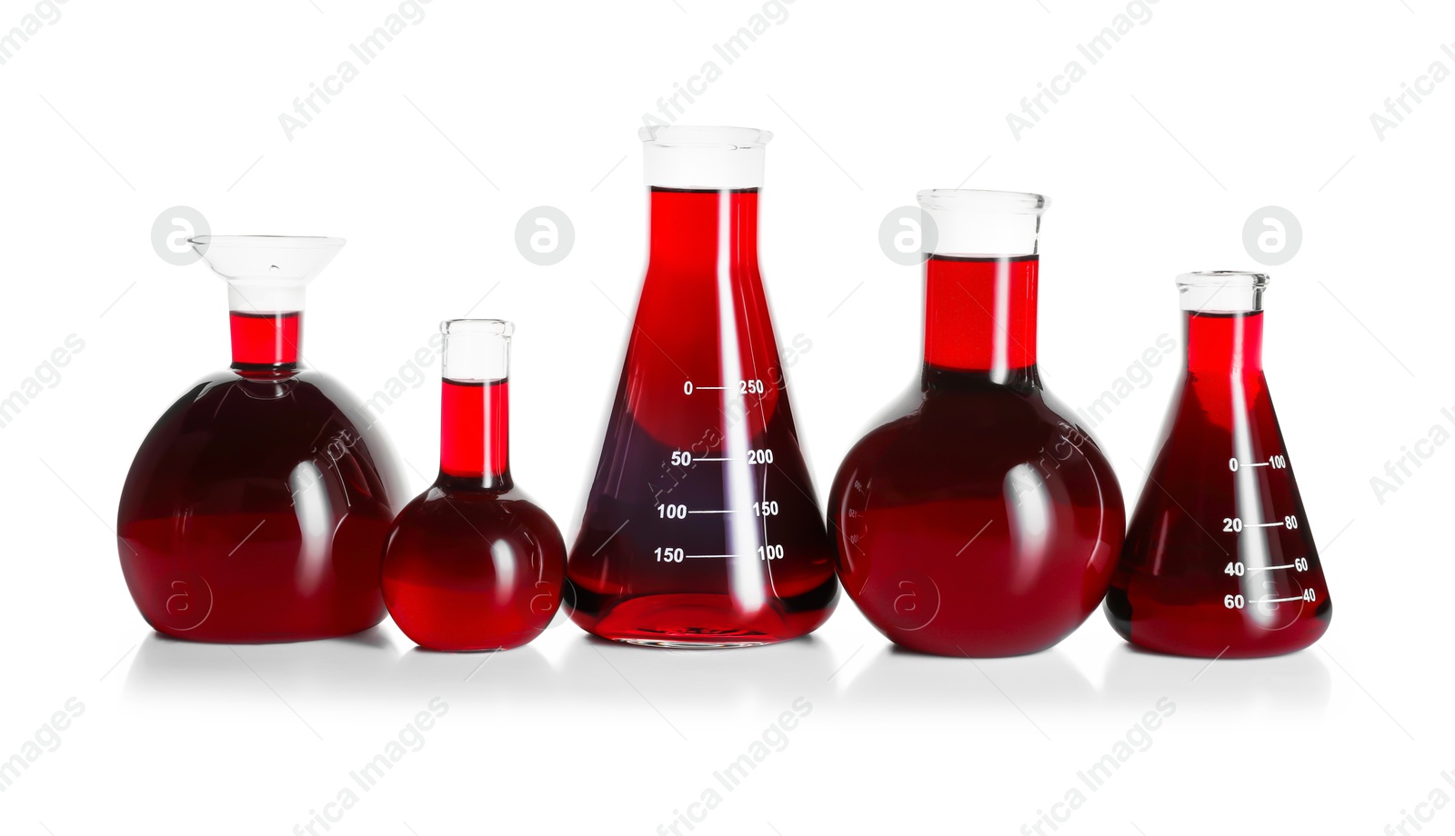 Photo of Laboratory glassware with red liquid isolated on white