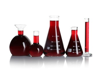Photo of Laboratory glassware with red liquid isolated on white