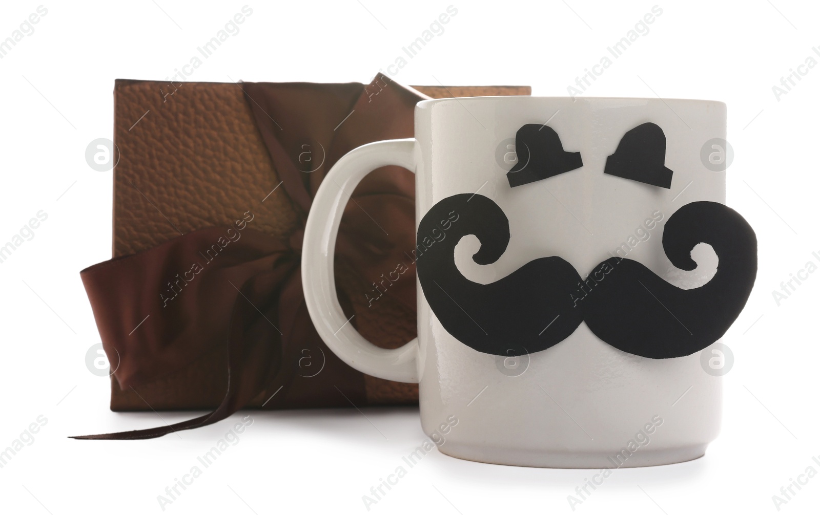 Happy Father's Day. Cup with paper face and gift box isolated on white Photo of Happy Father's Day. Cup with paper face and gift box isolated on white