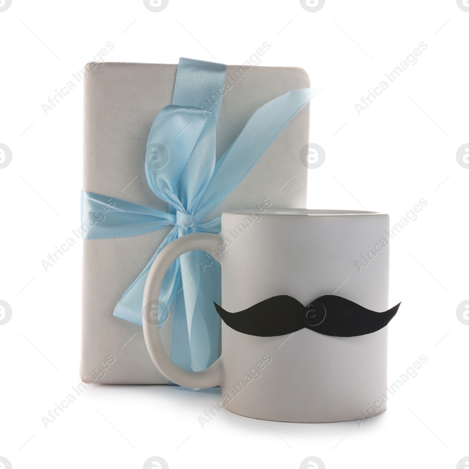 Photo of Happy Father's Day. Cup with mustache and gift isolated on white
