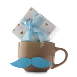 Photo of Happy Father's Day. Cup with mustache and gift box isolated on white